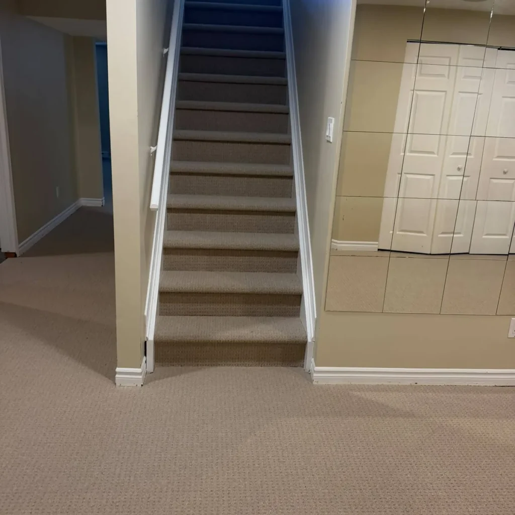 Basement stairs and floor in beige patterned loop carpet