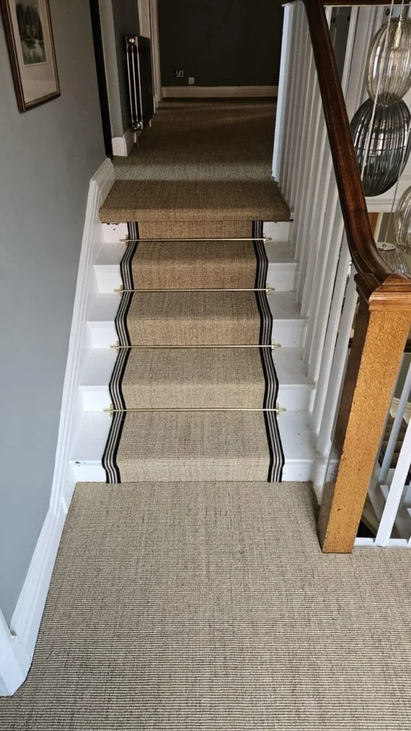 Textured stair runner with black bound edges on white stairs and landing in a Verona home